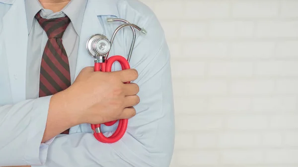Doktor steteskopu göğsüne dayamış, sıkı çalışmaya hazır.
