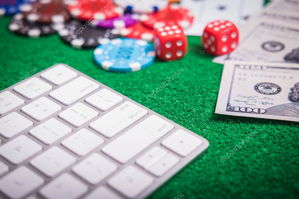 Gambling chips and cards on a green cloth Casino table