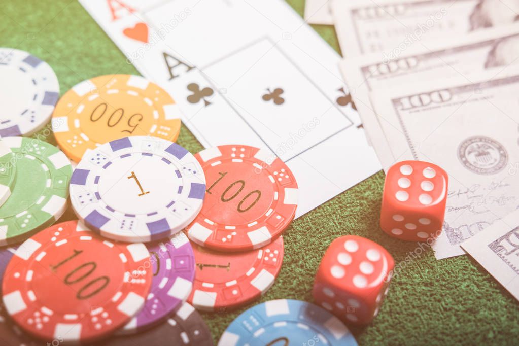 Gambling chips and cards on a green cloth Casino table