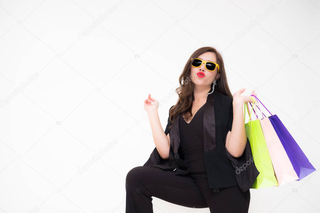 Beautiful young Asian woman holding bags from a recent shopping trip
