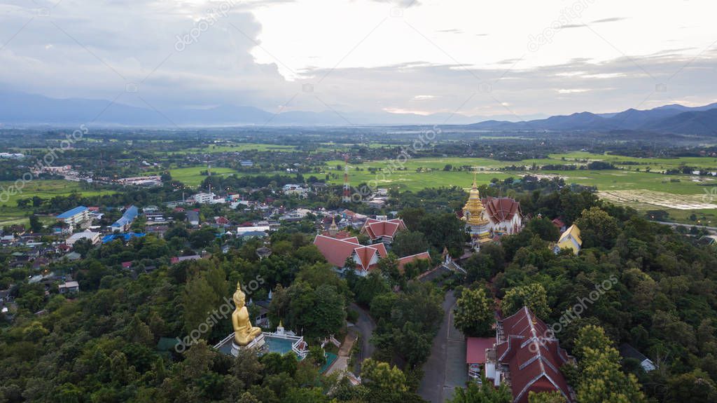 Aerial top view photo from flying drone of the Buddhist temple and fields in  the countryside of Chiang Mai,