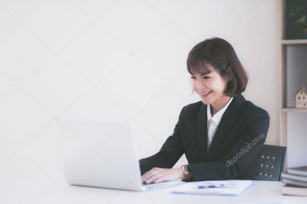 Young Asian woman working at a desk in business sector