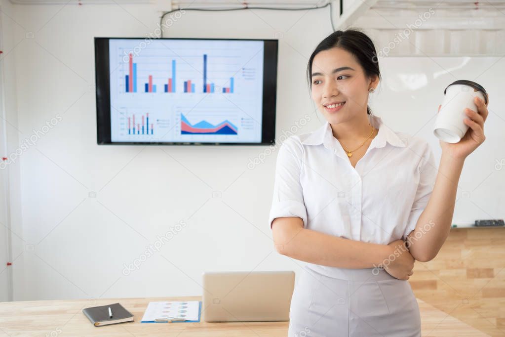 Portrait of smiling pretty young business woman on workplace, Calculating the cost of postage of a small package, Small business enterprise concerns for online Shopping