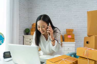 Genç Asyalı bir kadının küçük bir işi var, online satış yapıyor.