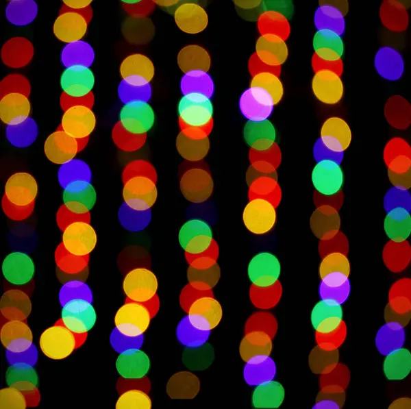 bokeh circles of different colors of light on a black background