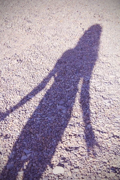 shadow of a girl on the beach in summer