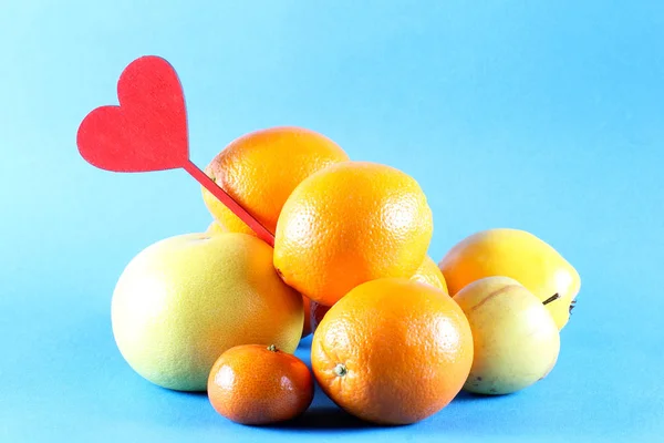 in a bucket lie fruits near the heart on a white background