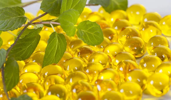 oil for health in round capsules of yellow color