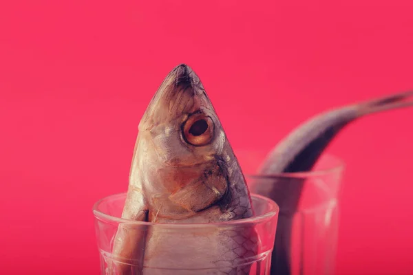 low salted herring in a cut glass on a bright background