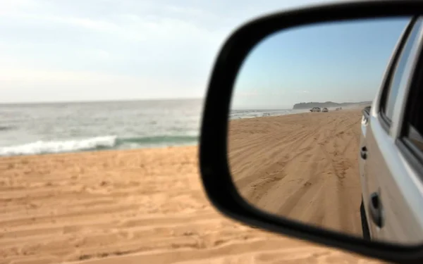 Car driving on beach — Stock Photo, Image