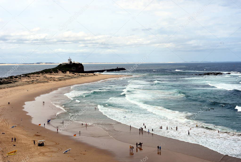 Beach at Newcastle with Nobbley's Lighthouse in the background 