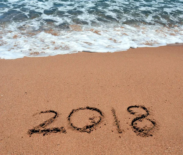 Happy New Year 2018, lettering on the beach. New Year 2018 is coming concept.