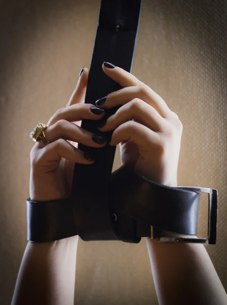 Kız deri kemer ile bağlı elleri vardır - yakın çekim - güzel tırnak manikür göstermek
