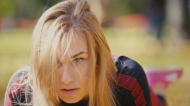Seksi çekici kadın sarışın bikini-fitness modeli zeminde sonbahar parkta uzanan sarı yapraklar - bacak asansörleri kapalı, yakın çekim