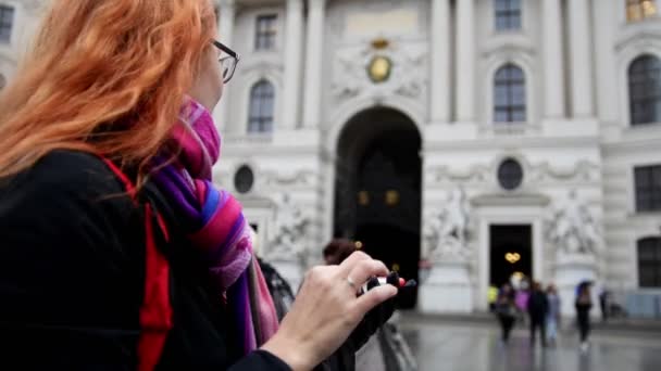 Mujer de pelo rojo joven usando el teléfono celular en Viena, gran angular, primer plano — Vídeo de stock