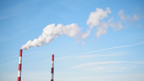 Chimneys of Power Plant on blue sky. White vapor from red tube, — Stock Video