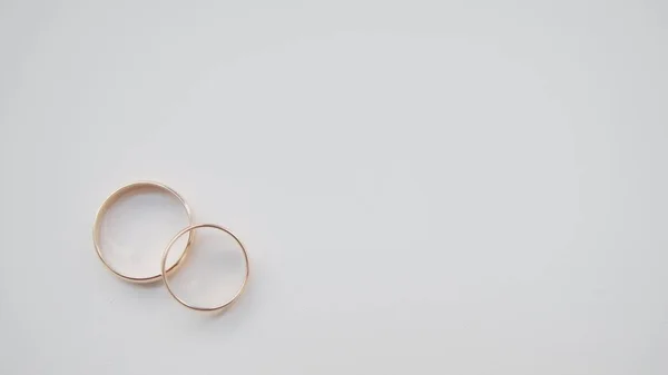 Золотые обручальные кольца на белом фоне — стоковое фото