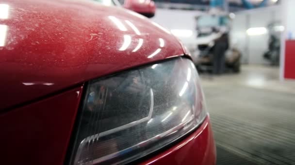 Dusty red car standing in auto service, slider shot — Stock Video