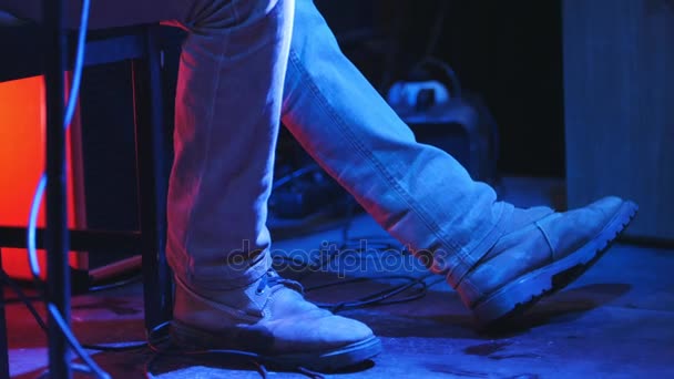 Guitarist at concert in club - view of legs — Stock Video