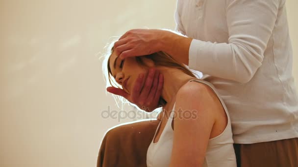 Male Masseur Holds The Thai Massage Session Flexing The Cervical Vertebrae And Head Of Female Stock Footage Male Masseur Holds The Thai Massage Session Flexing The Cervical Vertebrae And Head Of Female Stock Footage