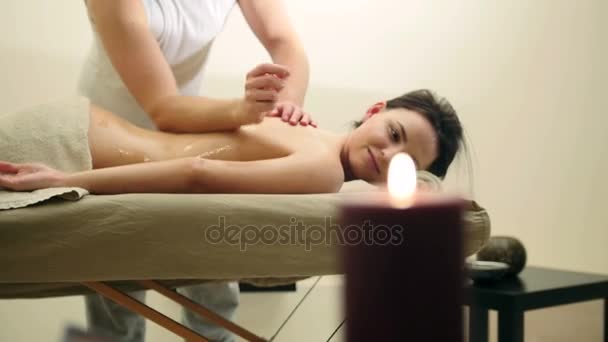 Massage de relaxation huile pour le dos. Homme frotte l'huile de sésame pour jeune femme, curseur — Video