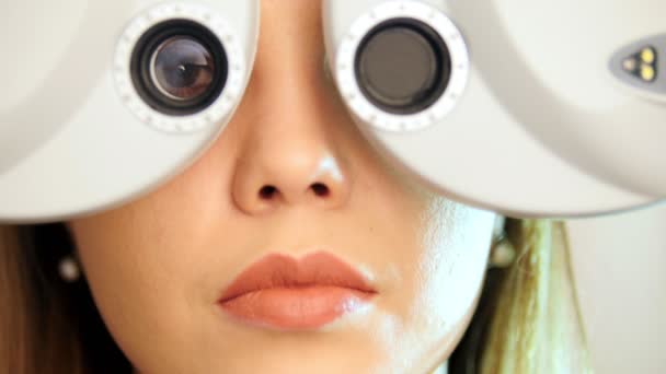 Ophthalmology clinic - woman checks vision by modern equipment, close up — Stock Video