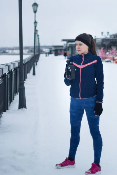 Portret van jonge sportieve vrouw op het werk uit - wintersneeuw buiten — Stockfoto