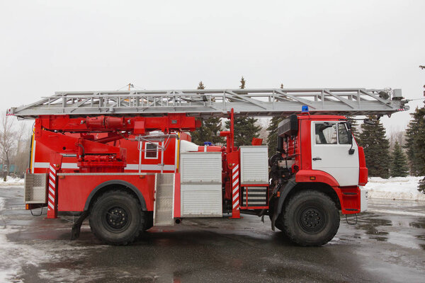 Fire truck with ladders and hoses - big red Russian fire fighting vehicle
