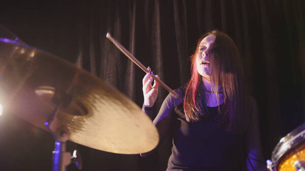 Teen garage rock music - attractive girl percussion drummer perform music break down