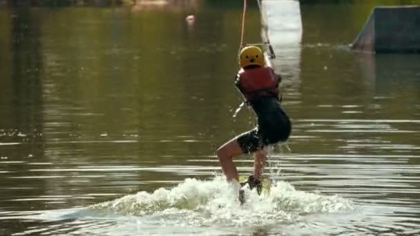 Young female wakeboarding in summer river - slow-motion — Stock Video