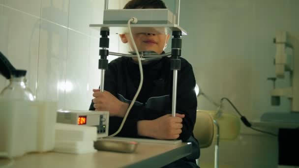 Clinica oftalmologica - bambino adolescente controlla la vista degli occhi con un dispositivo ad alta tecnologia — Video Stock