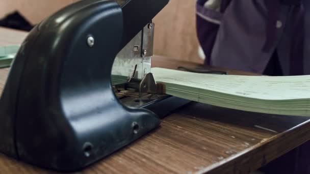 Hand of woman worker - stitching pages industrial stapler, polygraph industry, manual labour — Stock Video