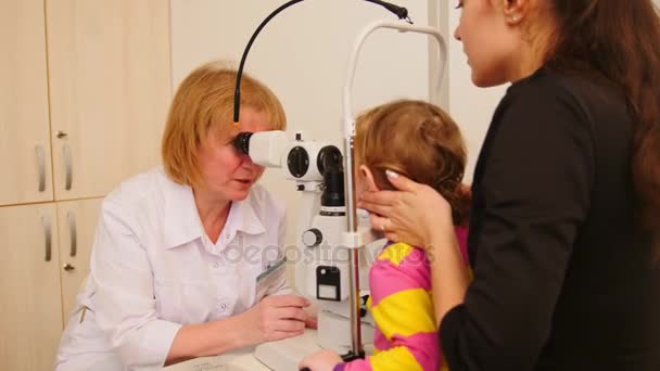 Malé dítě na ophthalmologys lékaře - optik zkontroluje zrak pro dívku — Stock video