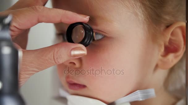 Cuidados de saúde - optometrista verificando pouca visão infantil - macro tiro — Vídeo de Stock