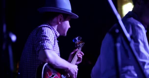 Musiker i hatt spelar gitarr på nattklubb, närbild — Stockvideo