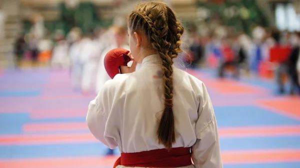 Sports kids - teenager girl sportsmen on karate use a protective mouthguard — Stock Photo, Image