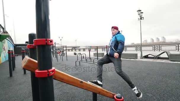Adolescente acrobático saltando en terrenos deportivos - realizando una voltereta hacia atrás, cámara lenta — Vídeos de Stock