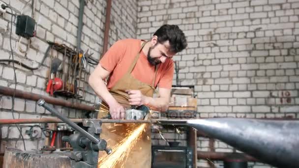 Beard man blacksmith forging an knife with circular saw — Stock Video