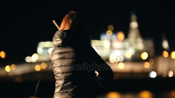 寒い季節の夜の街でヴァイオリンを演奏する女性ヴァイオリニストのシルエット — ストック動画