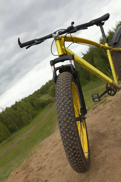 Direção de bicicleta gorda no campo de verão - bicicleta suja, horizontal — Fotografia de Stock