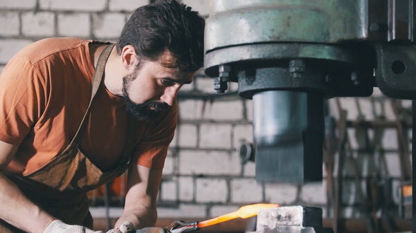 The blacksmith works with the item is removed from the fire