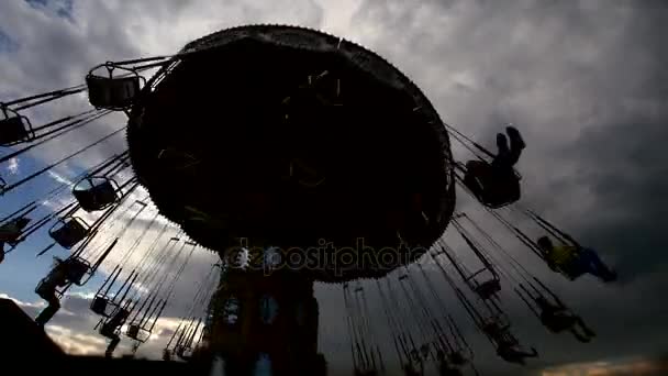 Rotating Carousel - silhouette against sunset, wide angle — Stock Video