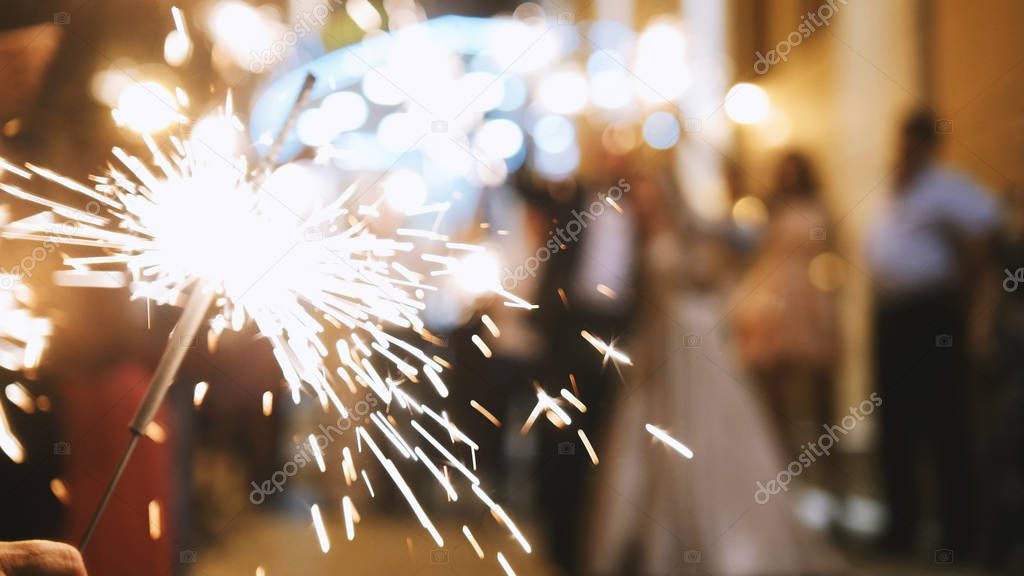 Fireworks in hands of guests - wedding evening