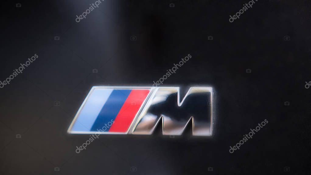 Kazan, Russia - july 2017 - logo sign for BMW M on black hood of the car, close up