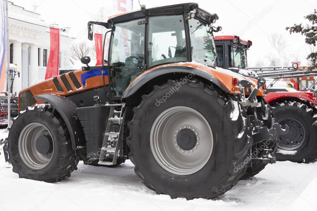 Agricultural tractor at winter snow day