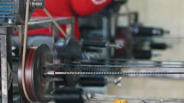 Producing of fiberglass reinforcement - machine is spinning the optical fiber wire — Stock Video