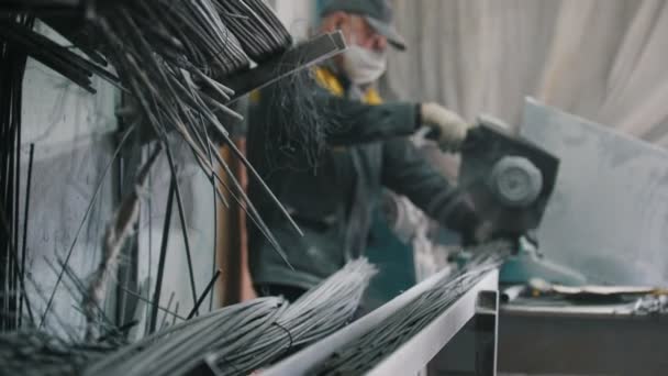 Worker cuts production on manufacturing of composite fiberglass reinforcement, de-focused — Stock Video