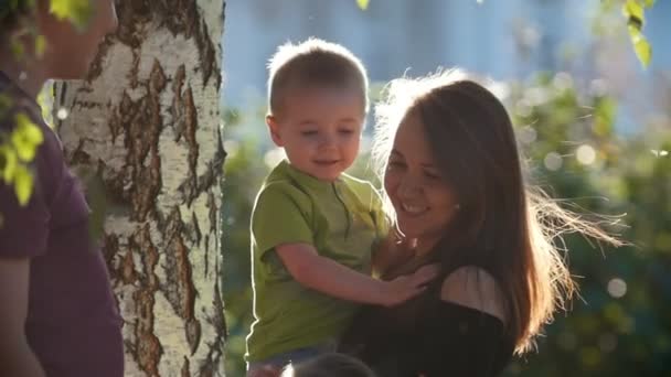 Happy family in the park at summer evening, slow-motion — Stock Video