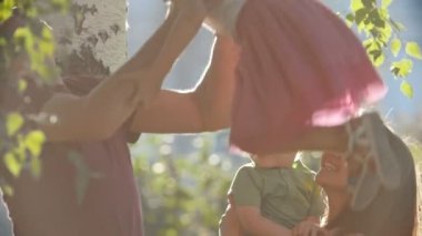 Mutlu aile - anne, baba ve çocuk - yaz akşam, parkta ağır çekim