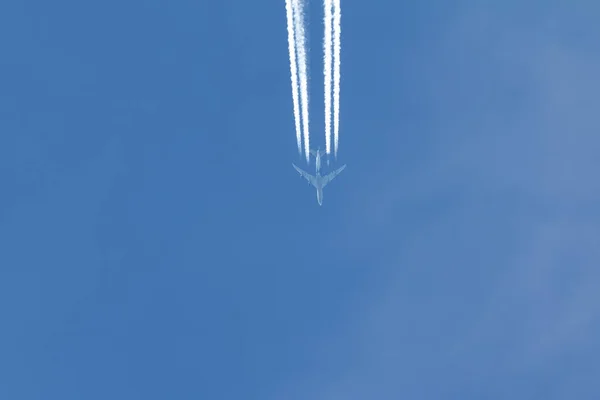 Jet is flying in the blue sky, horizontal — Stock Photo, Image